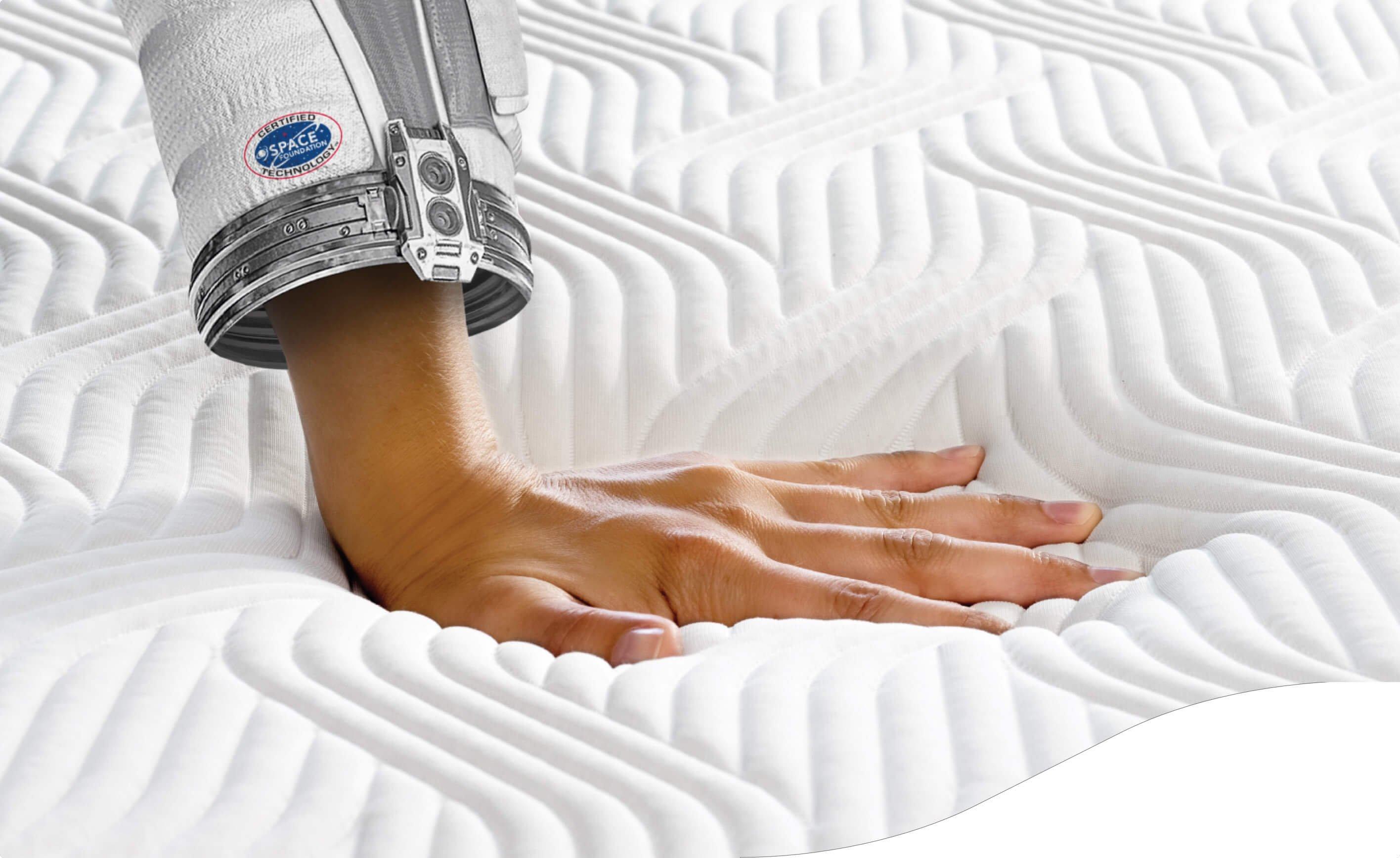 NASA astronaut hand on Tempur mattress
