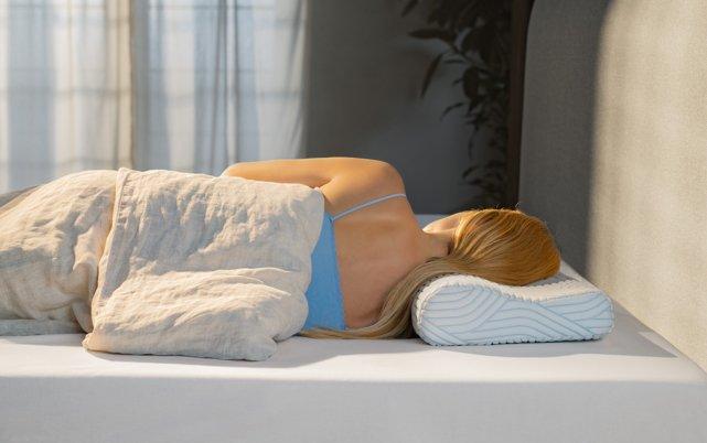 Woman laying on TEMPUR Pillow