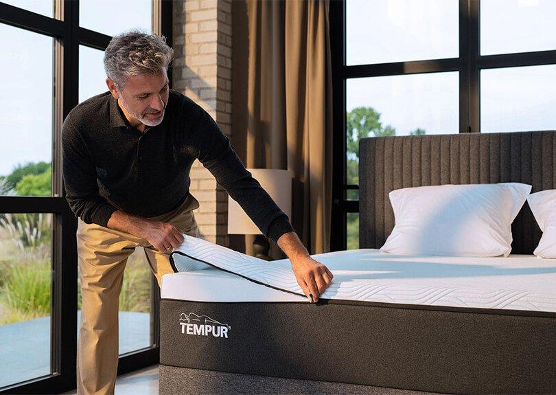 Tempur Mattress being zipped by happy man