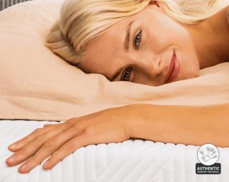 Tempur Mattress with a happy lady laying on it