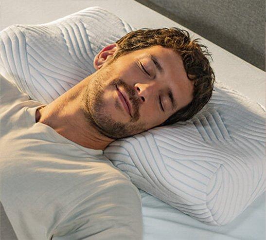 Tempur Ergonmic pillow with man sleeping on it