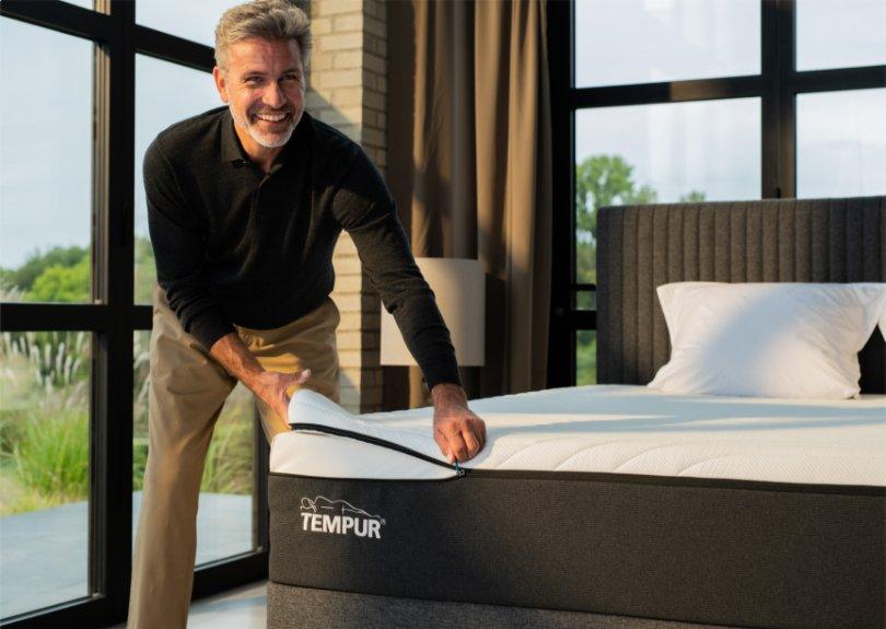 TEMPUR mattress cover being changed by a happy man