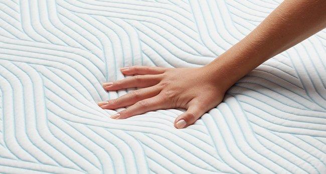 Hand sinks into
    mattress